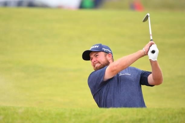 Ireland's Shane Lowry plays his approach shot from the 18th fairway during his first round on day one of The 149th British Open Golf Championship at...