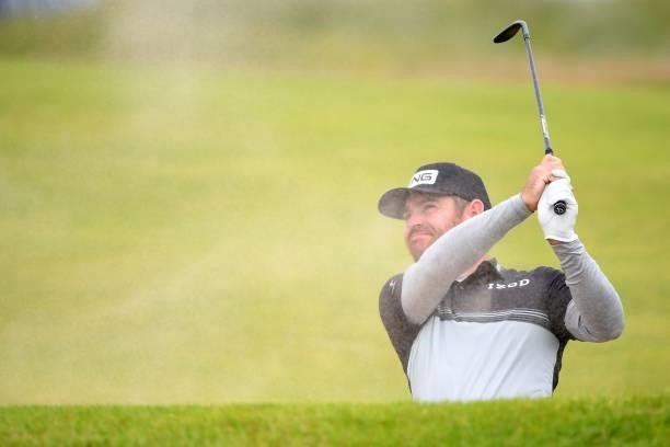 South Africa's Louis Oosthuizen plays from a bunker on the 18th hole during his first round 64 on day one of The 149th British Open Golf Championship...