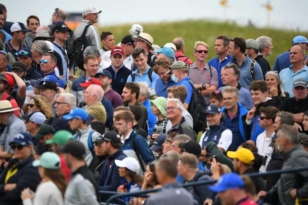 Spectators watch play on the opening day of The 149th British Open Golf Championship at Royal St George's, Sandwich in south-east England on July 15,...