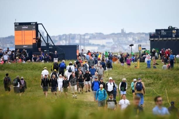 Spectators walk the course on the opening day of The 149th British Open Golf Championship at Royal St George's, Sandwich in south-east England on...