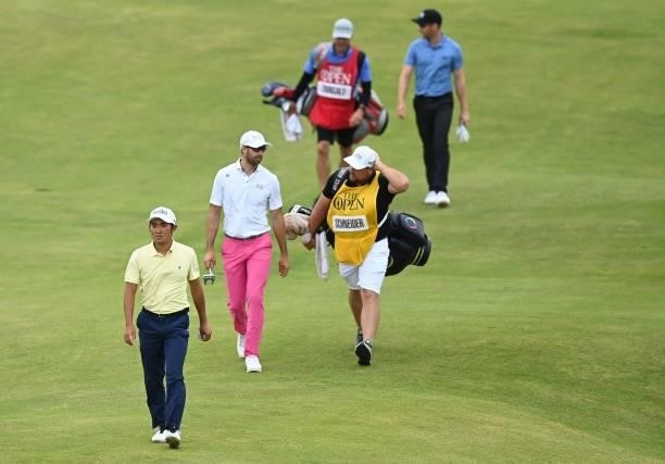 Japan's Takumi Kanaya leads his group onto the 15th green during his first round on day one of The 149th British Open Golf Championship at Royal St...