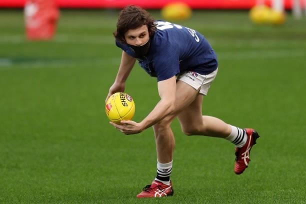 Max Holmes of the Cats warms up before the 2021 AFL Round 18 match between the Fremantle Dockers and the Geelong Cats at Optus Stadium on July 15,...