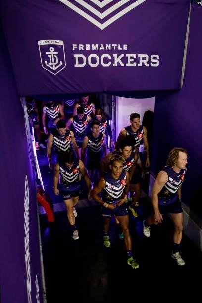 The Dockers walk out onto the field during the 2021 AFL Round 18 match between the Fremantle Dockers and the Geelong Cats at Optus Stadium on July...
