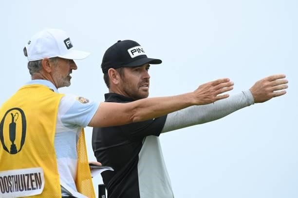 South Africa's Louis Oosthuizen speaks with caddie Colin Byrne on the 16th tee during his first round on day one of The 149th British Open Golf...
