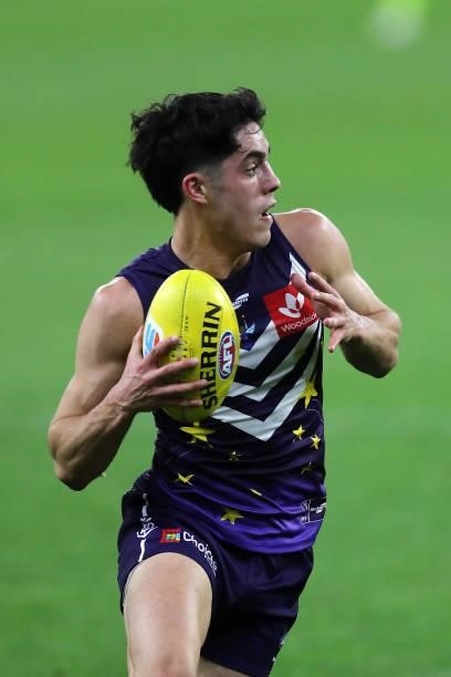 Adam Cerra of the Dockers looks to pass the ball during the 2021 AFL Round 18 match between the Fremantle Dockers and the Geelong Cats at Optus...