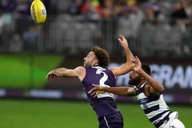 Griffin Logue of the Dockers and Esava Ratugolea of the Cats in action during the 2021 AFL Round 18 match between the Fremantle Dockers and the...