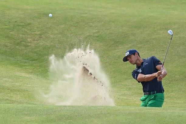 Golfer Johannes Veerman plays from a bunker on the 15th hole during his first round on day one of The 149th British Open Golf Championship at Royal...