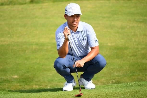 Golfer Xander Schauffele lines up a putt on the 6th green during his first round on day one of The 149th British Open Golf Championship at Royal St...