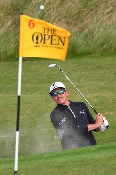 Golfer Rickie Fowler chips from a green-side bunker to the 6th green during his first round on day one of The 149th British Open Golf Championship at...