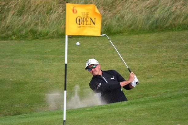 Golfer Rickie Fowler chips from a green-side bunker to the 6th green during his first round on day one of The 149th British Open Golf Championship at...