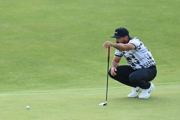 Australia's Jason Day lines up a putt on the 15th green during his first round on day one of The 149th British Open Golf Championship at Royal St...