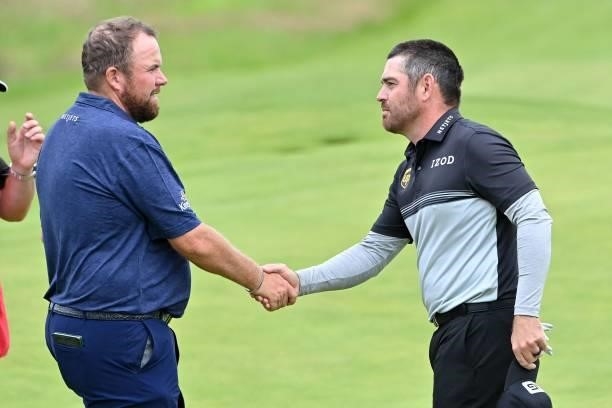 Ireland's Shane Lowry shakes hands with South Africa's Louis Oosthuizen after their first rounds on day one of The 149th British Open Golf...