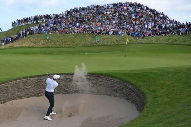 Northern Ireland's Rory McIlroy plays from the green-side bunker on the 6th hole during his first round on day one of The 149th British Open Golf...