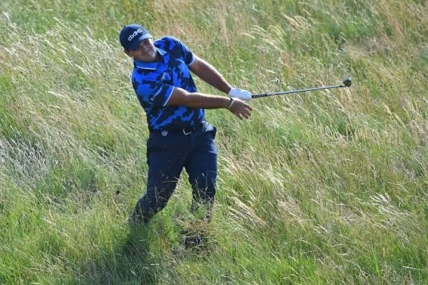 Golfer Patrick Reed plays from the rough on the 7th hole during his first round on day one of The 149th British Open Golf Championship at Royal St...