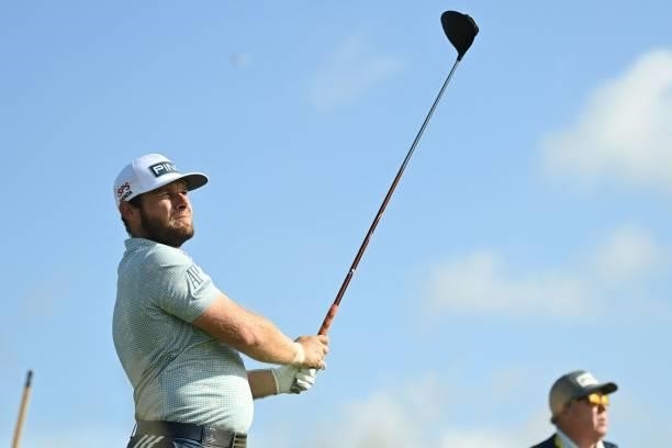 England's Tyrrell Hatton watches his drive from the 12th tee during his first round on day one of The 149th British Open Golf Championship at Royal...