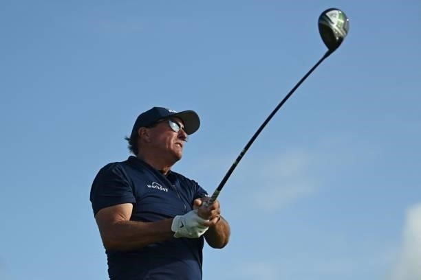 Golfer Phil Mickelson watches his drive from the 12th tee during his first round on day one of The 149th British Open Golf Championship at Royal St...