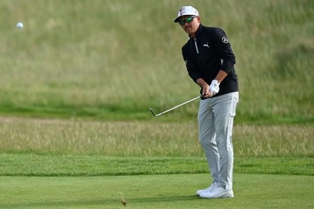 Golfer Rickie Fowler chips onto the 11th green during his first round on day one of The 149th British Open Golf Championship at Royal St George's,...