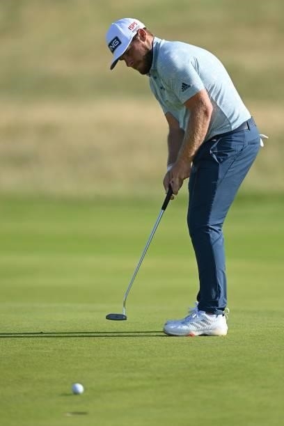 England's Tyrrell Hatton putts on the 11th green during his first round on day one of The 149th British Open Golf Championship at Royal St George's,...