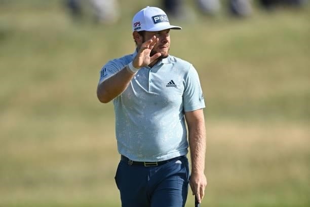 England's Tyrrell Hatton reacts after making his birdie putt on the 11th green during his first round on day one of The 149th British Open Golf...