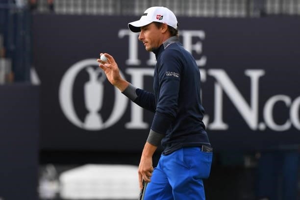 France's Benjamin Hebert reacts after making his par putt on the 18th green during his first round on day one of The 149th British Open Golf...