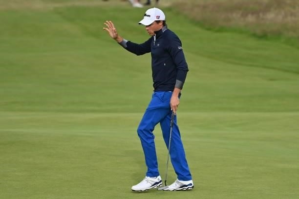 France's Benjamin Hebert reacts after making his par putt on the 18th green during his first round on day one of The 149th British Open Golf...