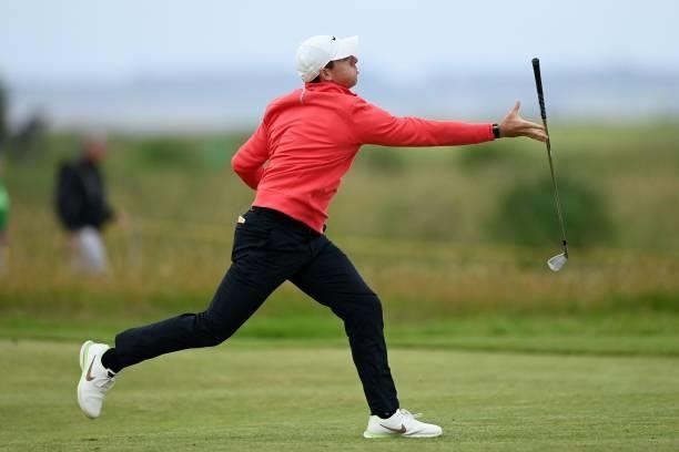 Northern Ireland's Rory McIlroy fails to catch his club after throwing it in the air on the 15th fairway during his first round on day one of The...