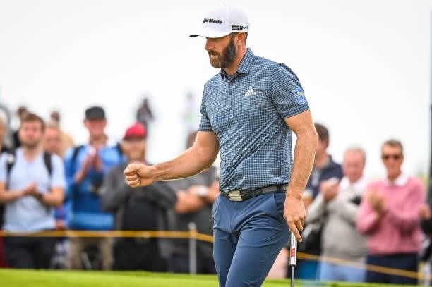 Dustin Johnson celebrates with a fist pump after making a birdie putt on the 15th hole green during Day One of the 149th The Open Championship at...