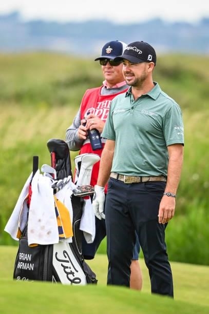 Brian Harman smiles with his caddie on the 14th hole during Day One of the 149th The Open Championship at Royal St. Georges Golf Club on July 15,...