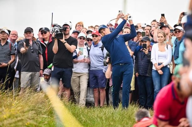 Jordan Spieth plays a shot from the rough on the 14th hole as fans watch during Day One of the 149th The Open Championship at Royal St. Georges Golf...