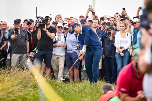 Jordan Spieth plays a shot from the rough on the 14th hole as fans watch during Day One of the 149th The Open Championship at Royal St. Georges Golf...