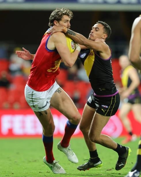 Joe Daniher shrugs off a tackle during the 2021 AFL Round 18 match between the Richmond Tigers and the Brisbane Lions at Metricon Stadium on July 16,...