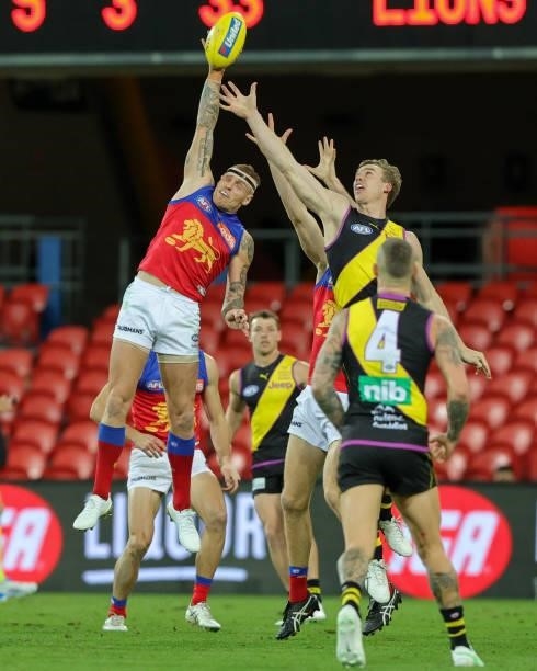 Mitch Robinson attempts a spoil during the 2021 AFL Round 18 match between the Richmond Tigers and the Brisbane Lions at Metricon Stadium on July 16,...