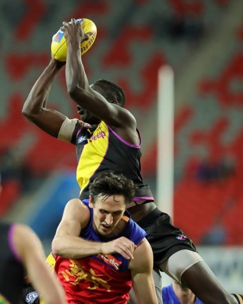 Mabior Chol takes a big mark during the 2021 AFL Round 18 match between the Richmond Tigers and the Brisbane Lions at Metricon Stadium on July 16,...