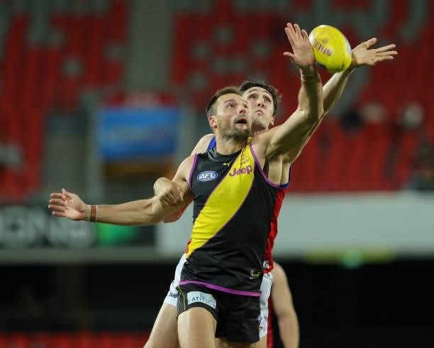 Oscar McInerney and Toby Nankervis contest the ruck during the 2021 AFL Round 18 match between the Richmond Tigers and the Brisbane Lions at Metricon...