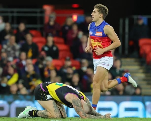 Dustin Martin lays injured on the ground during the 2021 AFL Round 18 match between the Richmond Tigers and the Brisbane Lions at Metricon Stadium on...