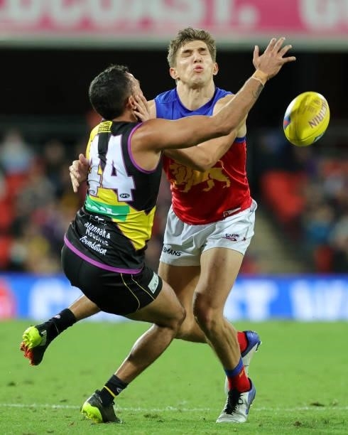 Sydney Stack and Zac Bailey collide during the 2021 AFL Round 18 match between the Richmond Tigers and the Brisbane Lions at Metricon Stadium on July...