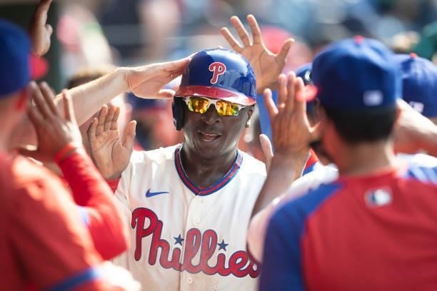 Didi Gregorius of the Philadelphia Phillies high fives his teammates after scoring a run in the bottom of the first inning against the Miami Marlins...