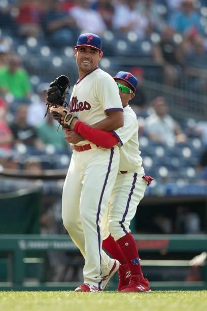 Matt Moore of the Philadelphia Phillies catches the ball and then Ronald Torreyes hugs him in the top of the first inning against the Miami Marlins...