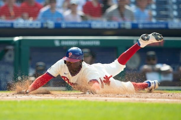 Didi Gregorius of the Philadelphia Phillies slides home safely in the bottom of the first inning against the Miami Marlins during Game One of the...
