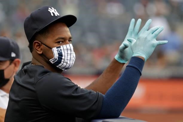 Luis Severino of the New York Yankees wears a mask and gloves during the first inning of the game against the Boston Red Sox at Yankee Stadium on...