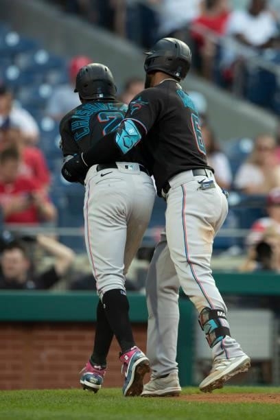 Starling Marte of the Miami Marlins celebrates with Jazz Chisholm Jr. #2 after hitting a two-run home run in the top of the first inning against the...