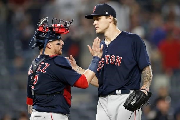 Tanner Houck of the Boston Red Sox celebrates with Christian Vazquez of the Boston Red Sox after defeating the New York Yankees at Yankee Stadium on...