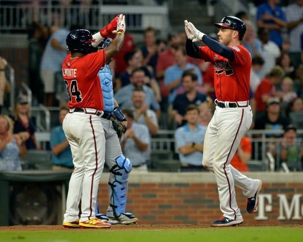 Freddie Freeman of the Atlanta Braves celebrates with Abraham Almonte after hitting a two-run home run in the fifth inning against the Tampa Bay Rays...