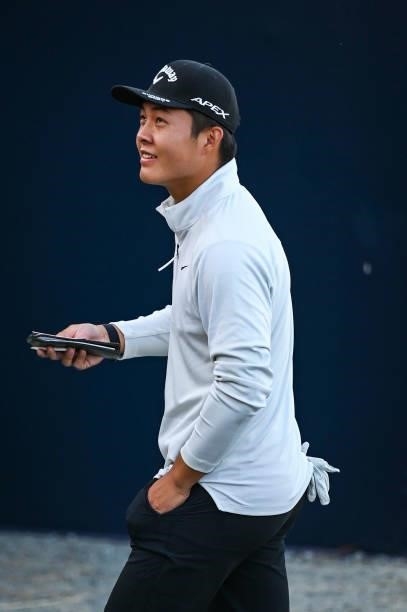 Amateur Yuxin Lin of China smiles as he walks off the 18th hole green after saving par to make the cut during Day Two of the 149th The Open...