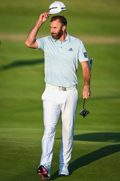 Dustin Johnson tips his cap to fans on the 18th hole green during Day Two of the 149th The Open Championship at Royal St. Georges Golf Club on July...