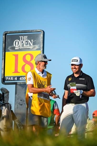 Louis Oosthuizen of South Africa smiles with his caddie on the 18th tee during Day Two of the 149th The Open Championship at Royal St. Georges Golf...
