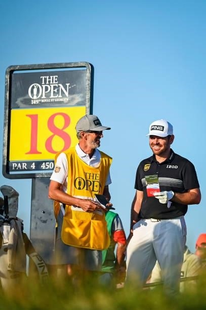 Louis Oosthuizen of South Africa smiles with his caddie on the 18th tee during Day Two of the 149th The Open Championship at Royal St. Georges Golf...