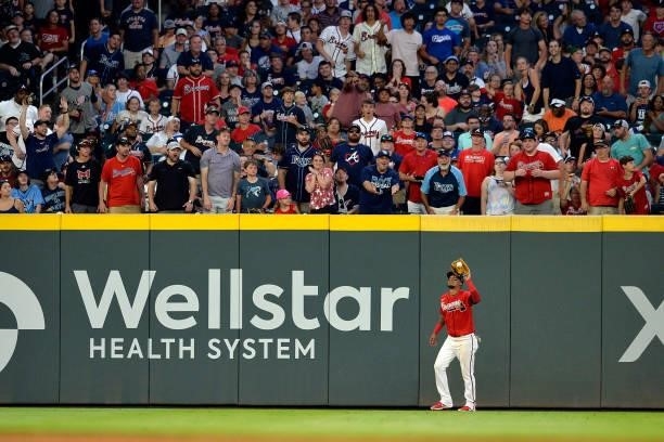 Orlando Arcia of the Atlanta Braves fields a fly ball to end the fifth inning against the Tampa Bay Rays at Truist Park on July 16, 2021 in Atlanta,...
