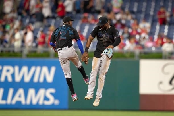 Jazz Chisholm Jr. #2 and Starling Marte of the Miami Marlins celebrate their win against the Philadelphia Phillies after Game Two of the doubleheader...