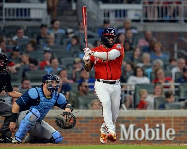 Abraham Almonte of the Atlanta Braves makes a base hit in the fifth inning against the Tampa Bay Rays at Truist Park on July 16, 2021 in Atlanta,...